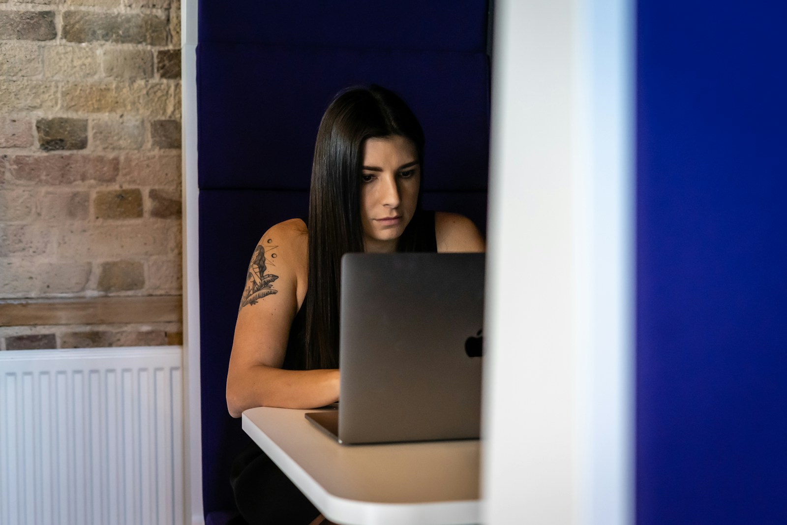 a woman sitting in front of a laptop computer